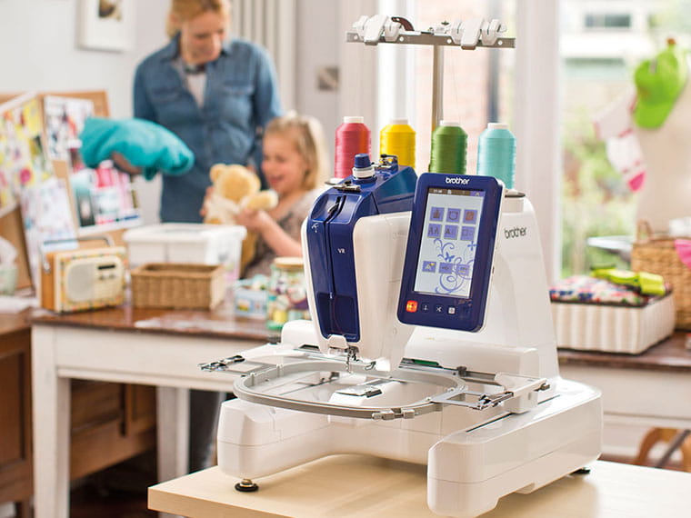 VR embroidery machine with mom and daughter in background